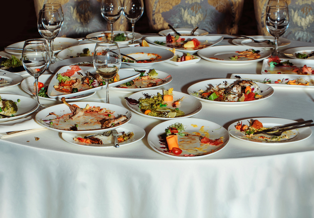 a restaurant table covered with plates with half-eaten food