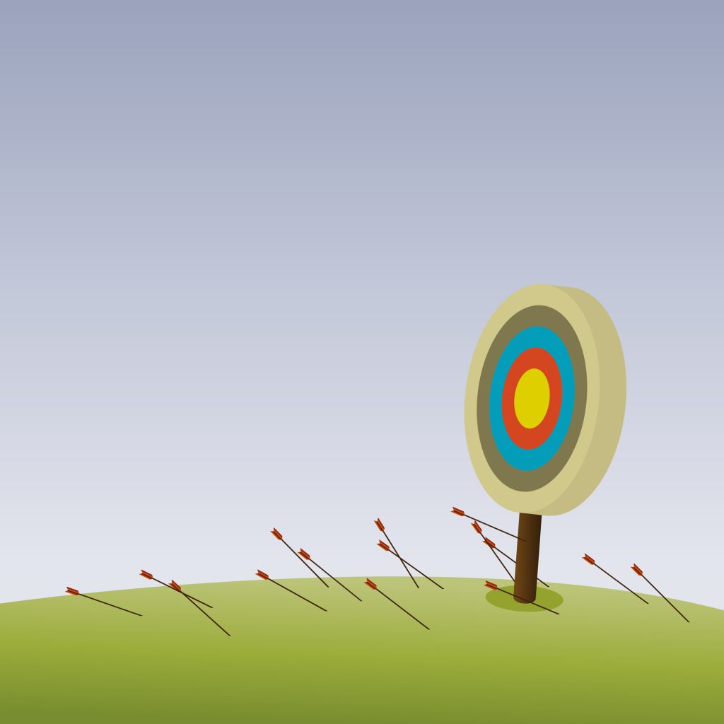 a bullseye with arrows on sticking into the ground around it