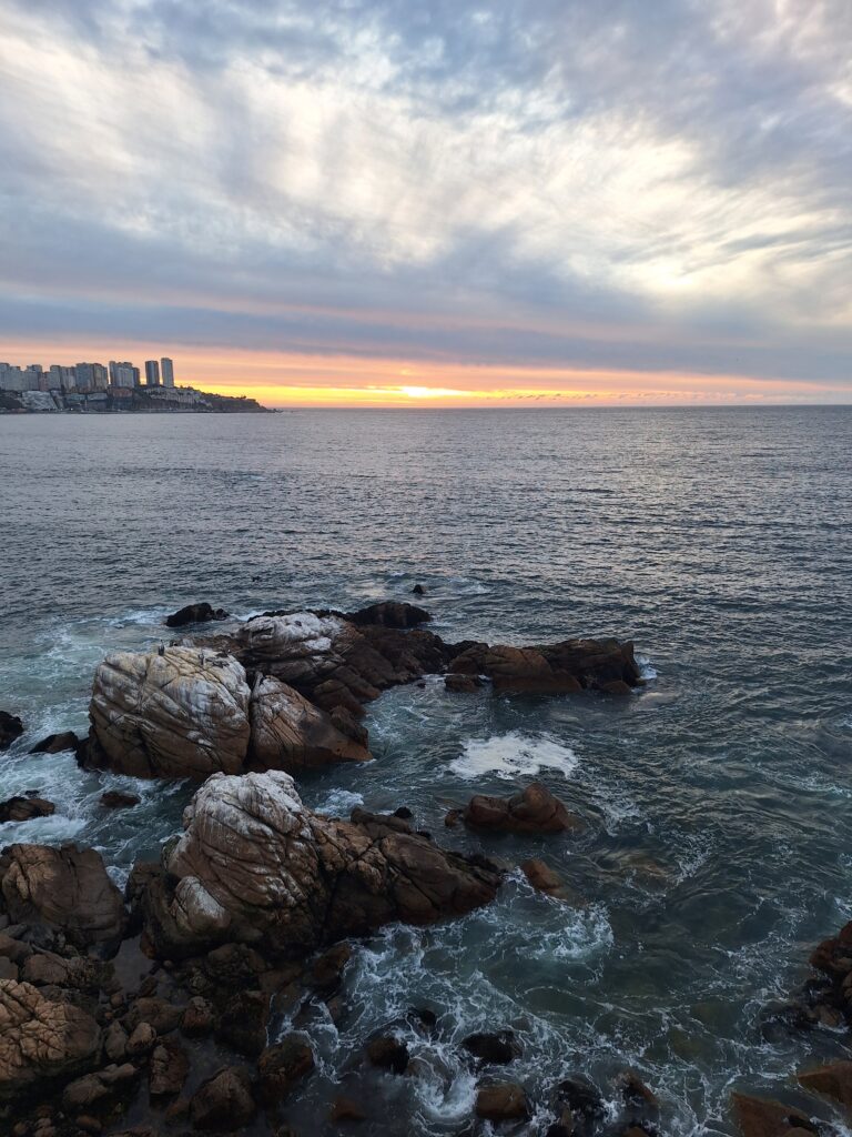 the Chilean coastline showing the sky with clouds and rocks in the ocean